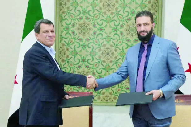 Syrian President Ahmed al-Sharaa shakes hands with Mazloum Abdi, commander of the "Syrian Democratic Forces" in Damascus, March 10, 2025 (SANA)