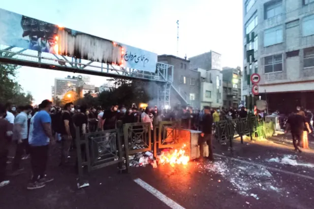 People light a fire during a protest over the death of Mahsa Amini, a woman who died after being arrested by the Islamic republic's "morality police", in Tehran, Iran September 21, 2022. WANA (West Asia News Agency) via REUTERS 