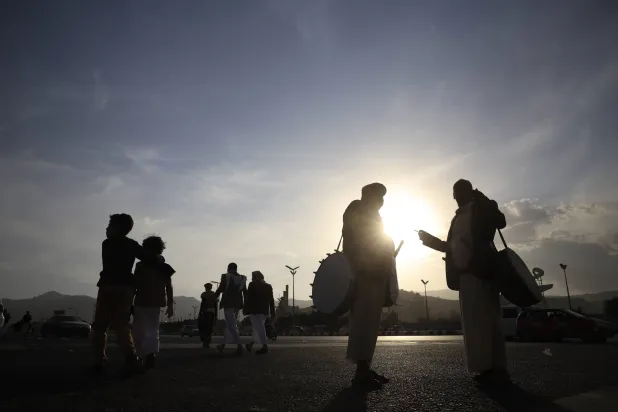 People walk along a street at sunset in Sanaa, Yemen, 21 January 2026. (EPA)