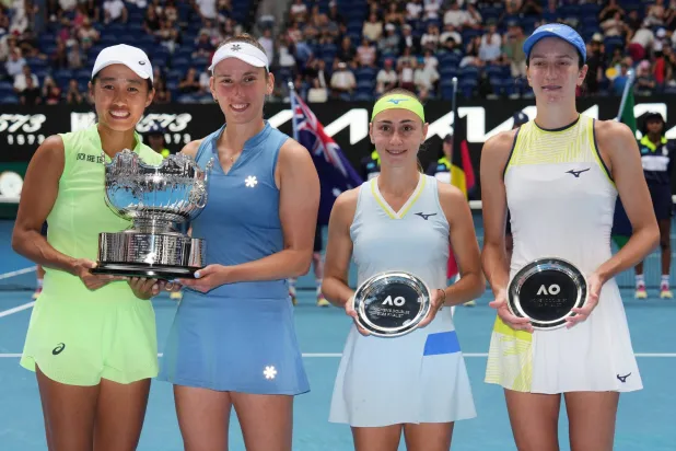 Elise Mertens of Belgium and Zhang Shuai, left, of China pose with their trophy after defeating Anna Danilina, right, of Kazakhstan and Aleksandra Krunic of Serbia in the women's doubles final at the Australian Open tennis championship in Melbourne, Australia, Saturday, Jan. 31, 2026. (AP Photo/Aaron Favila)