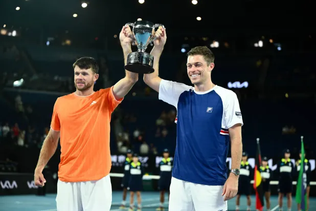 Christian Harrison (L) of the USA and Neal Skupski (R) of Great Britian pose with the winners trophy after winning the men’s doubles final against Jason Kubler and Marc Polmans  of Australia on day 14 of the 2026 Australian Open tennis tournament at Melbourne Park in Melbourne, Australia, 31 January 2026. EPA/JOEL CARRETT 
