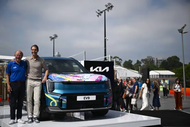 Spanish former tennis player Rafael Nadal (2-L) poses for a photo with former Australian Open driver Iain Moffat (L) during a branding partnership event during day 14 of the 2026 Australian Open tennis tournament at Melbourne Park in Melbourne, Australia, 31 January 2026.  EPA/JOEL CARRETT