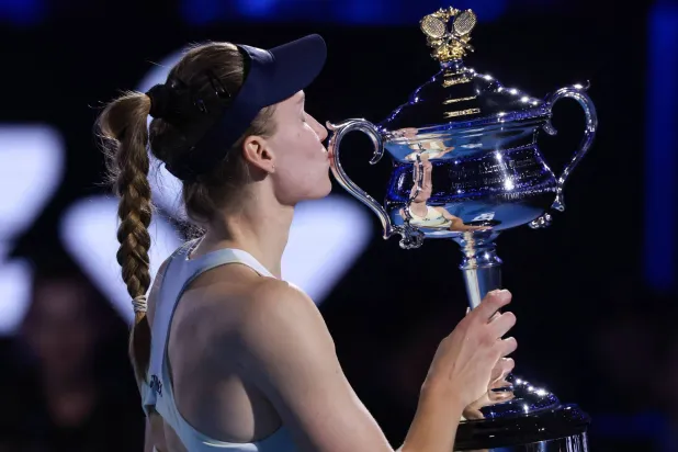 Kazakhstan's Elena Rybakina celebrates with the Daphne Akhurst Memorial Cup after her victory against Belarus' Aryna Sabalenka during the women's singles final match on day fourteen of the Australian Open tennis tournament in Melbourne on January 31, 2026. (Photo by DAVID GRAY / AFP)