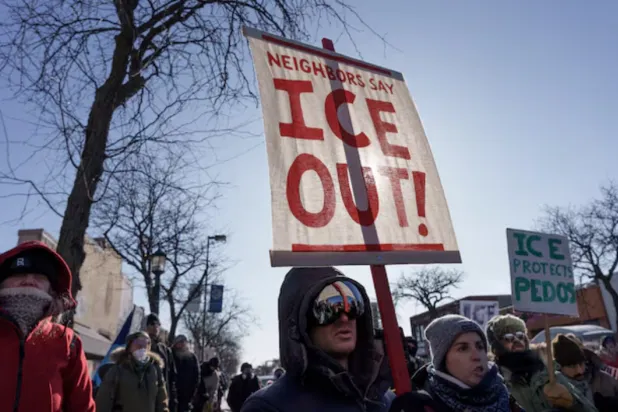 Demonstrators carry signs condemning Immigration and Customs Enforcement (ICE) near the site where a man identified as Alex Pretti was fatally shot by federal agents trying to detain him, in Minneapolis, Minnesota, US, January 24, 2026. REUTERS/Tim Evans/File Photo 