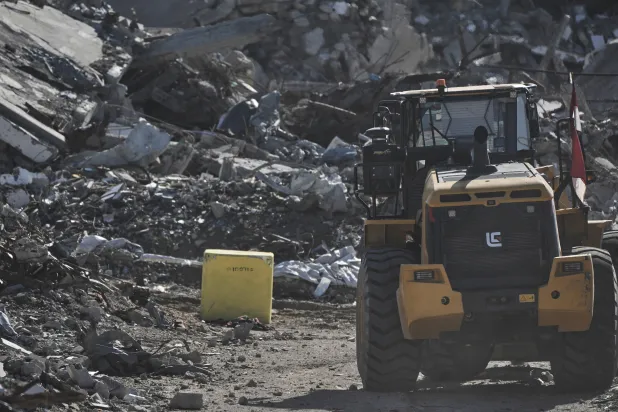 A yellow block demarcating the "Yellow Line," which has separated the Gaza Strip's Israeli-held and Palestinian zones since the October ceasefire, is visible in Jabalia, northern Gaza Strip, where Hamas militants are searching for the remains of hostages, Monday, Dec. 1, 2025. (AP Photo/Jehad Alshrafi) 