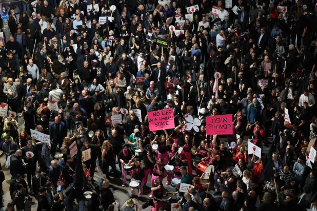 مشاركون في مسيرة احتجاجية ضد تفشي الجريمة بالمجتمعات العربية في إسرائيل في تل أبيب يوم السبت (إ.ب.أ)