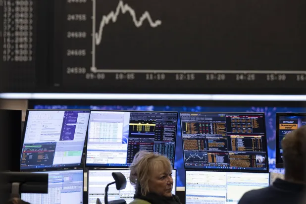 يتابع متداولو الأسهم اتجاه الأسعار على شاشاتهم في بورصة فرانكفورت (د.ب.أ)