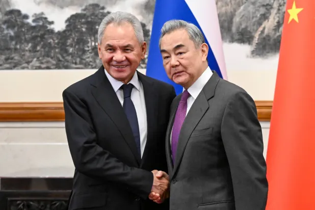 01 February 2026, China, Beijing: Russian Security Council Secretary Sergei Shoigu (L) and China's Minister of Foreign Affairs Wang Yi shake hands during a meeting. (Maxim Blinov/TASS via ZUMA Press/dpa)