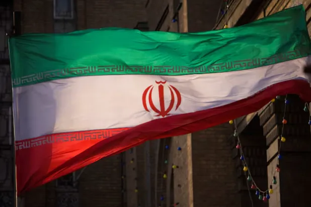 Iranian flag is pictured in front of Iran's Foreign Ministry building in Tehran November 23, 2009. REUTERS/Morteza Nikoubazl (IRAN POLITICS)/File Photo