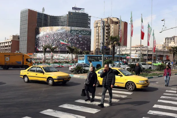  Iranians walk in a street in Tehran, Iran, 02 February 2026. (EPA)