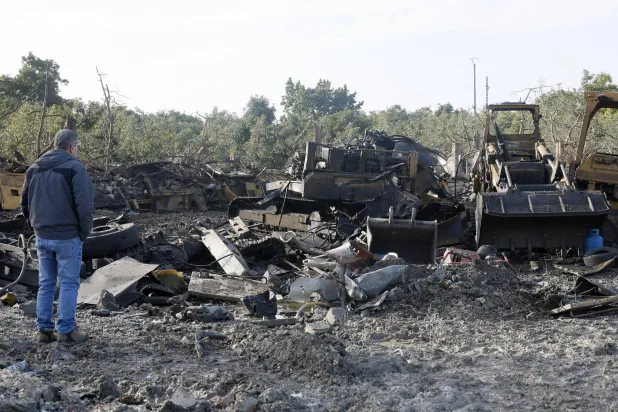 A person inspects a site a day after a series of Israeli airstrikes targeted a large industrial machine in the village of Marwaniyah, southern Lebanon, last January 31 (EPA)