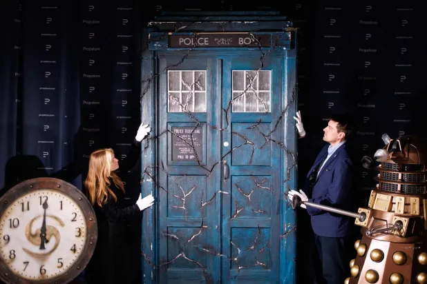 Propstore employees pose with a screen-matched TARDIS (C), a Bronze Asylum Dalek (R) and a Sardickton Clock (L), which were used in the filming of the "Doctor Who" TV series, during a photocall for the upcoming "Doctor Who" auction by Propstore auction house in Rickmansworth, Hertfordshire, Britain, 30 January 2026. (EPA)