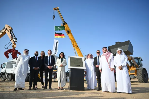 02 February 2026, Saudi Arabia, Jeddah: German Minister for Economic Affairs and Energy Katherina Reiche (C) poses for a photo during a visit to the Mercedes Benz Heavy Duty Trucks and Saudi Liebherr Company Ltd construction site in the Juffali Industrial Park. (dpa)