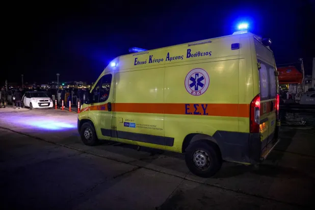 An ambulance is seen at the port on the eastern Aegean island of Chios, on February 3, 2026, following a migrant boat collision with Greek coastguards. (Handout / Eurokinissi / AFP)
