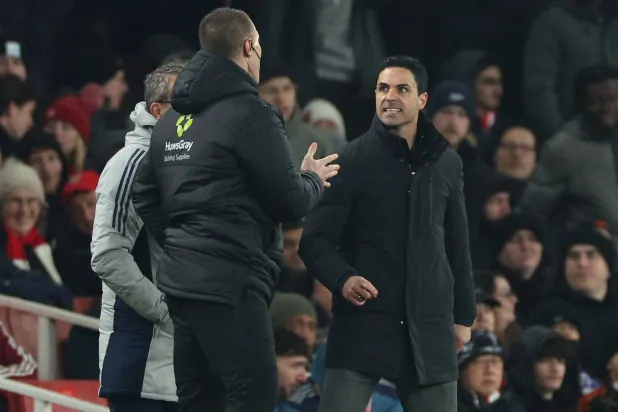 Arsenal's Spanish manager Mikel Arteta (R) clashes with the fourth official Thomas Bramall (L) during the English League Cup semi-final second leg football match between Arsenal and Chelsea at the Emirates Stadium, in London on February 3, 2026. (AFP)