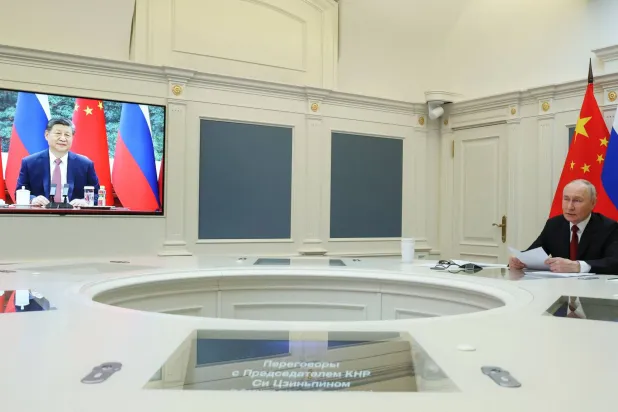 In this pool photograph distributed by the Russian state agency Sputnik, Russia's President Vladimir Putin holds a video call with Chinese President Xi Jinping in Moscow on February 4, 2026. (Vyacheslav Prokofyev/ Pool/ AFP)