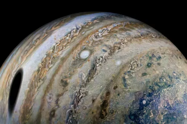 An enhanced-color image, using raw data from the JunoCam instrument aboard NASA's Juno spacecraft, shows the planet Jupiter, with a shadow of its moon Ganymede on the left, released by NASA on April 21, 2022. NASA/JPL-Caltech/SwRI/MSSS/Image processing by Thomas Thomopoulos/Handout via REUTERS 