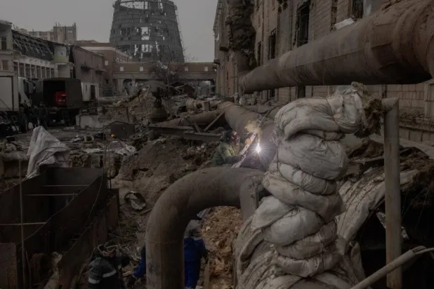 Employees repair sections of the Darnytska combined heat and power plant damaged by Russian air strikes in Kyiv, on February 4, 2026, during the Russian invasion of Ukraine. Roman PILIPEY / AFP
