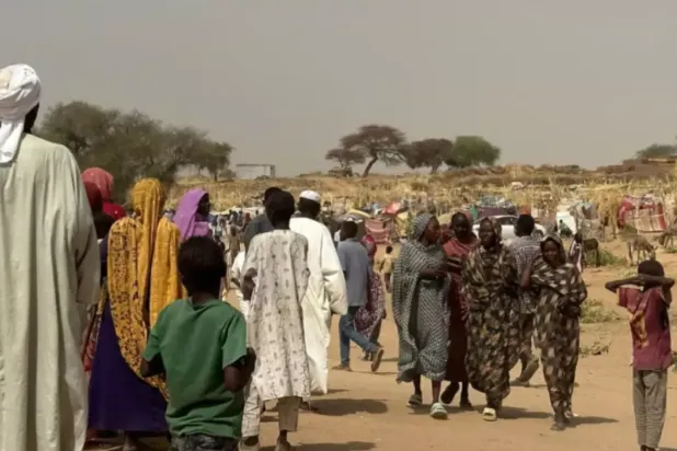 People who fled the Zamzam camp for the internally displaced walk in a makeshift encampment in an open field near the town of Tawila in war-torn Sudan's western Darfur region on April 13, 2025. © AFP
