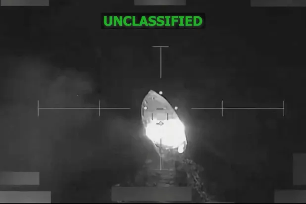 A vessel that the US military said was suspected of smuggling drugs, burns after being struck with a kinetic weapon in a location given as the Eastern Pacific, in this screengrab taken from a handout video released December 18, 2025. US Southern Command/Handout via REUTERS