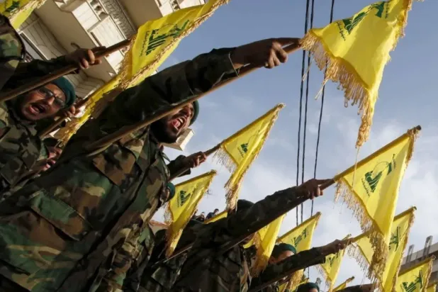 Lebanon’s Hezbollah members carry Hezbollah flags during the funeral of a fellow fighter, in al-Ghaziyeh village, southern Lebanon May 26, 2015. REUTERS/Ali Hashisho