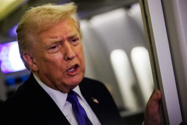 US President Donald Trump gaggles with reporters while aboard Air Force One on February 6, 2026 en route to Palm Beach, Florida. (Getty Images via AFP) 