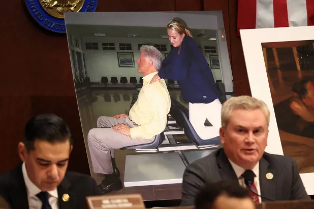 Images of former US President Bill Clinton are on display as Chairman of the House Oversight Committee James Comer (R-KY) speaks during a meeting to vote on whether to hold Clinton and former Secretary of State Hillary Clinton in contempt of Congress for defying subpoenas to testify in the panel's investigation of the late convicted offender Jeffrey Epstein, on Capitol Hill in Washington, D.C., US, January 21, 2026. REUTERS/Kevin Lamarque
