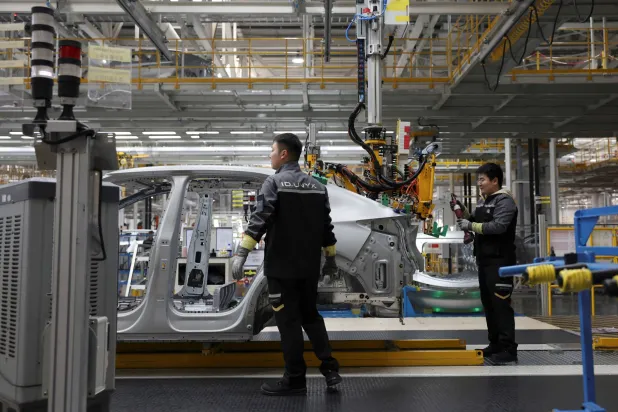 Employees work on an electric vehicle (EV) production line at the Volkswagen Anhui factory in Hefei, Anhui province, China, February 4, 2026. REUTERS/Florence Lo