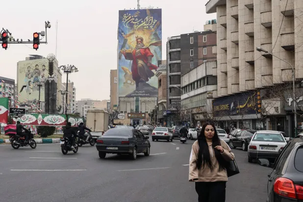 Traffic moves through a street in Tehran on February 7, 2026. (Photo by ATTA KENARE / AFP)