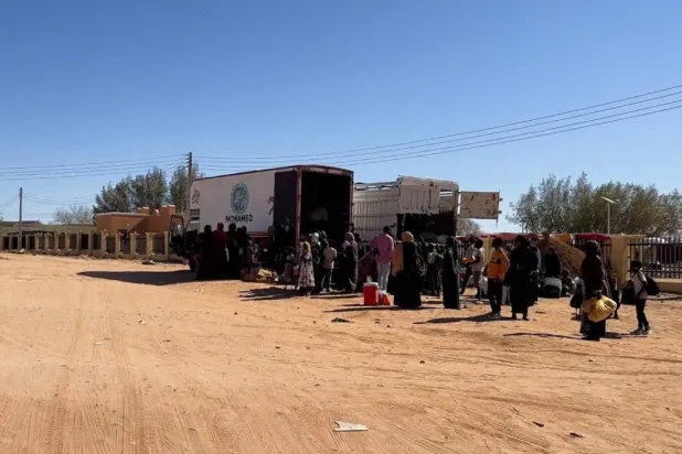 Sudanese families prepare to ride on trucks while on their way to Egypt through the Qustul border, after the crisis in Sudan's capital Khartoum, in the Sudanese city of Wadi Halfa, Sudan May 1, 2023. (Reuters)
