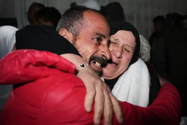 Ayada Al-Sheikh is welcomed by his sister, Nisreen, upon his arrival in Khan Younis in the southern Gaza Strip after returning to Gaza following the long-awaited reopening of the Rafah border crossing, early Thursday, Feb. 5, 2026. (AP Photo/Abdel Kareem Hana)

