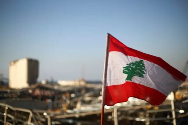 A Lebanese flag is pictured, in the aftermath of a massive explosion, in Beirut's damaged port area, Lebanon August 17, 2020. REUTERS/Hannah McKay 