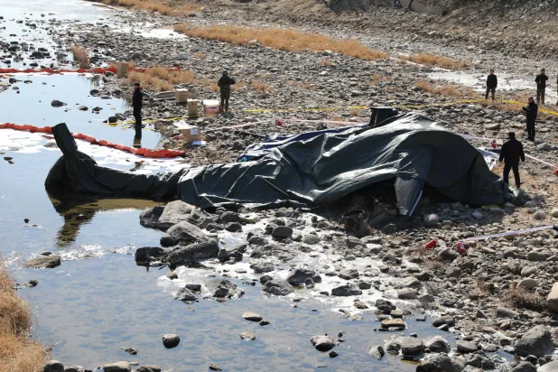 South Korean military officials secure the site where an AH-1S Cobra attack helicopter crashed in Gapyeong, South Korea, February 9, 2026. Yonhap via REUTERS   
