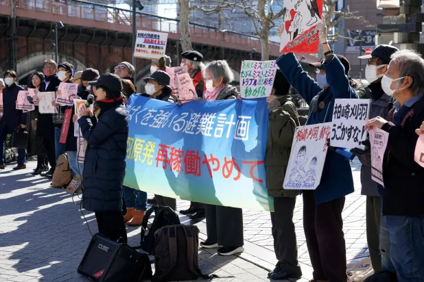 Participants demonstrate in front of Tokyo Electric Power Company's headquarters against the restart of the Kashiwazaki-Kariwa Nuclear Power Plant, in Tokyo on February 9, 2026. (Photo by Kazuhiro NOGI / AFP)