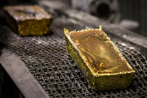 Gold bars being washed after removal from molds at a refinery in Sydney (AFP)