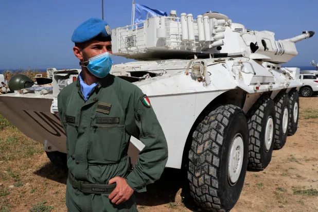 An Italian UN peacekeeper soldier stands guard at a road that links to a United Nations Interim Force In Lebanon (UNIFIL) base, in Naqoura town, Lebanon, on May 4, 2021. (AP)