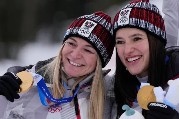 النمساويتان أريان ريدلر «يسار» وكاثارينا هوبر تحتفلان بذهبية الفرق (أ.ب)