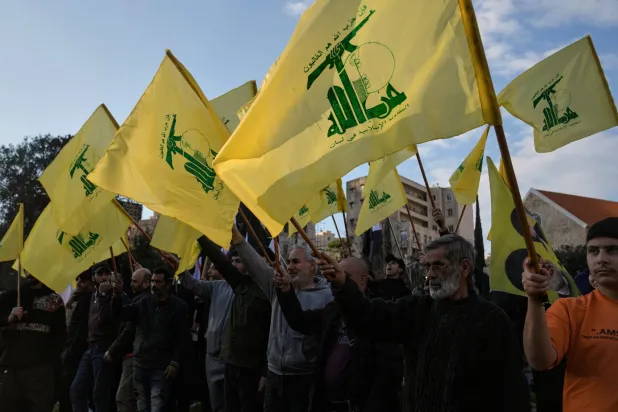 Hezbollah supporters raise their group's flags during a protest condemning recent Israeli military actions in Lebanon and calling on the international community to intervene as tensions escalate along the southern border, outside the headquarters of the UN Economic and Social Commission for Western Asia, ESCWA, in Beirut, Lebanon, Wednesday, Feb. 4, 2026. (AP) 