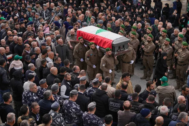 Lebanese special forces policemen carry the coffins of their comrade Hassan Jaber, who was killed on Monday with his son Ali, by an Israeli drone attack, during their funeral procession in Yanouh village, south Lebanon, Tuesday, Feb. 10, 2026. (AP)