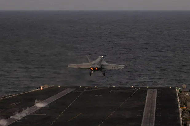 In this handout photograph released by the US Navy on February 5, 2026, an F/A-18E Super Hornet, attached to Strike Fighter Squadron (VFA) 14, launches from the flight deck of Nimitz-class aircraft carrier USS Abraham Lincoln in the Arabian Sea on February 3, 2026. (AFP / US Navy / Mass Communication Specialist Seaman Zoe Simpson)