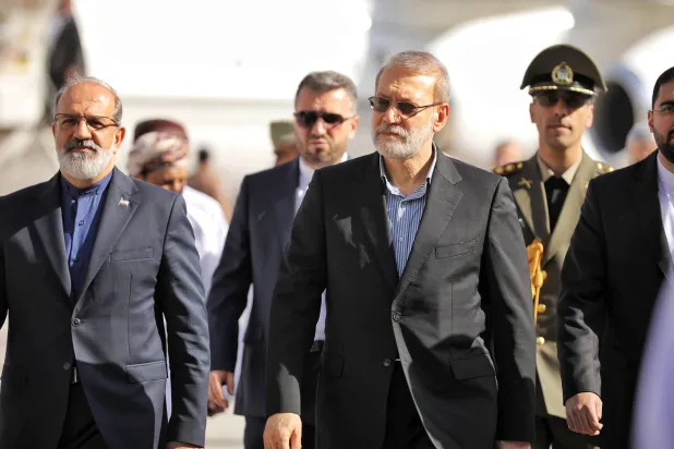 A handout photo made available by Iran's Supreme National Security Council office shows Secretary of the Supreme National Security Council Ali Larijani (C) arriving in Muscat, Oman, 10 February 2026. (EPA/ Iran's Supreme National Security Council office / Handout) 