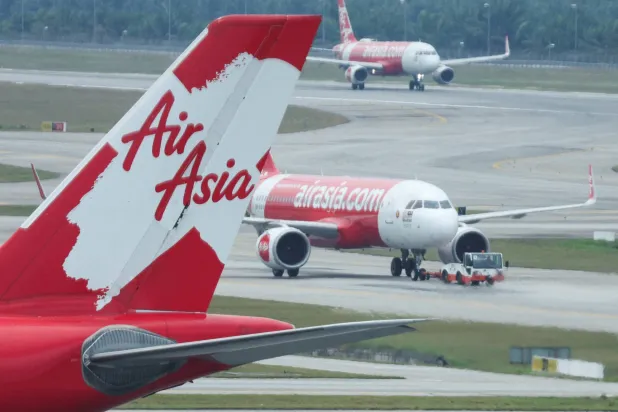 FILE PHOTO: Planes from AirAsia are seen on the tarmac of Kuala Lumpur International Airport Terminal 2 (KLIA2) in Sepang, Malaysia, February 26, 2024. REUTERS/Hasnoor Hussain/File Photo