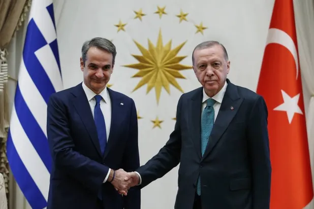 In this photo released by the Turkish Presidency, Türkiye’s President Recep Tayyip Erdogan, right, and Greece's Prime Minister Kyriakos Mitsotakis, shake hands during their meeting in Ankara, Türkiye, Wednesday, Feb. 11, 2026. (Turkish Presidency via AP) 