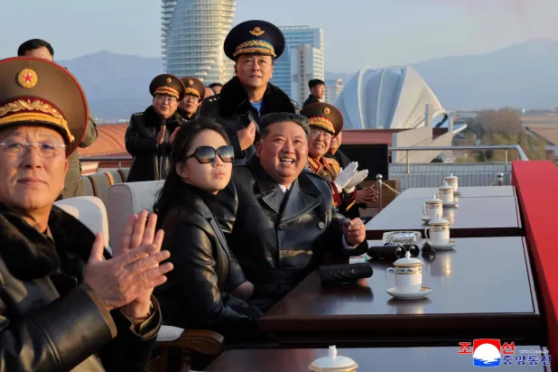 (FILES) This picture taken on November 28, 2025 and released by North Korea's official Korean Central News Agency (KCNA) on November 30, 2025 shows North Korean leader Kim Jong Un (3rd L) and his daughter Ju Ae (2nd L) watching a demonstration flight commemorating the 80th anniversary of the founding of the Korean People's Army Air Force at Kalma Airfield in Wonsan, Gangwon Province. (Photo by KCNA VIA KNS / AFP) 