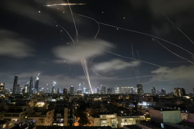 The Israeli Iron Dome air defense system intercepts missiles during an Iranian attack on Tel Aviv, Israel, June 18, 2025. (AP Photo/Leo Correa, File)

