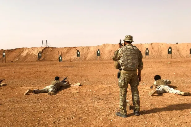 FILE: Members of the Maghawir al-Thawra Syrian opposition group receive firearms training from US Army Special Forces soldiers at the al-Tanf military outpost in southern Syria in 2018. (AP/Lolita Baldor)
