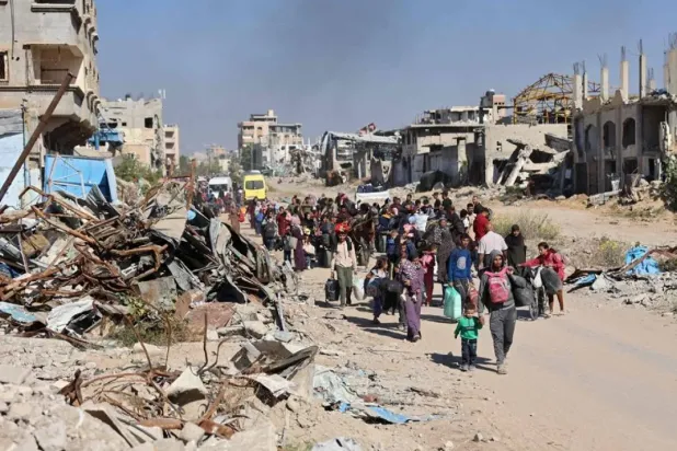 Displaced Palestinians fleeing Israeli military operations in Beit Lahia in the northern Gaza strip walk along the Salah al-Din main road in eastern Gaza City making their way to the city center, on October 22, 2024, amid the ongoing war in the Palestinian territory between Israel and Hamas. (AFP)
