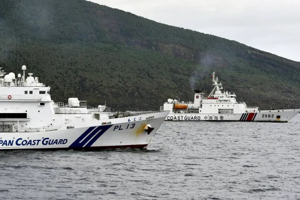 A China Coast Guard vessel No.2502 sails near a Japan Coast Guard vessel Motobu off Uotsuri Island, one of a group of disputed islands called Senkaku Islands in Japan, also known in China as Diaoyu Islands, in the East China Sea April 27, 2024, in this photo released by Kyodo. Mandatory credit Kyodo/via REUTERS   