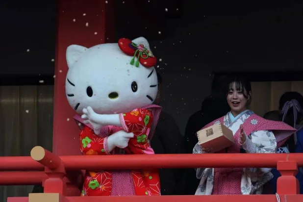 A participant dressed as Hello Kitty throws beans during the annual Setsubun ceremony to celebrate the upcoming arrival of spring. (Reuters)