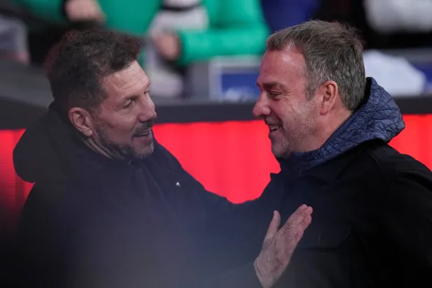 Atletico Madrid's head coach Diego Simeone, left, and Barcelona's head coach Hansi Flick greet each other before the Copa del Rey semi-final first leg soccer match between Atletico Madrid and Barcelona in Madrid, Spain, Thursday, Feb. 12, 2026. (AP)